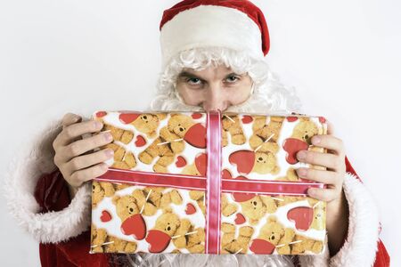 Jolly Santa Claus with a gift in their handsの写真素材