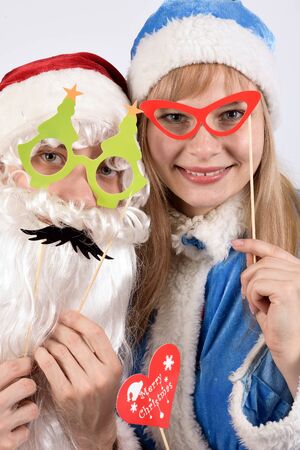 Santa Claus and Snow Maiden in masquerade masksの写真素材