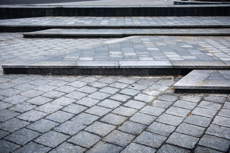 paving tiles laid in beautiful ornaments on a city streetの写真素材