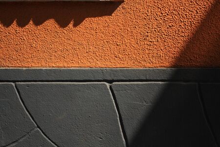 Gray and orange plaster wall texture. Architectural backgroundの写真素材