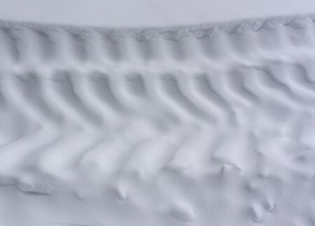 Tire tracks on snow. Background and texture.