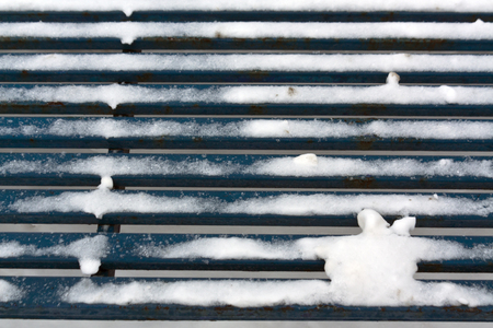 Blue bench in snow. Seasonal background.の写真素材