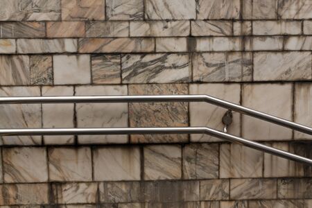 Metal handrail and grungy wall. Architectural background.の写真素材