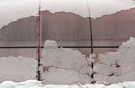 Plastic private greenhouse in snow. Seasonal backgroundの写真素材