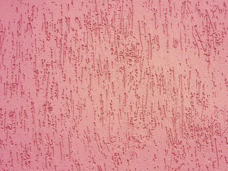 Pink color plaster wall texture. Architectural background.の写真素材