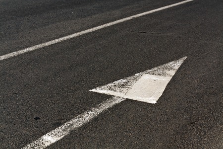 Line and arrow on asphalt surface. Road and signs