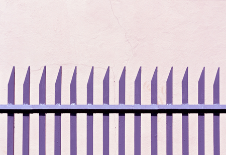 Color metal fence and plaster wall. Architectural background and texture.の写真素材