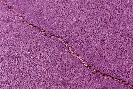 Cracked color asphalt surface. Abstract background and texture for design and ideas.の写真素材