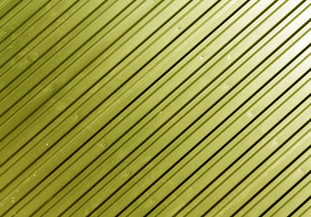 Yellow metal plate surface. Abstract background and texture for design.の写真素材