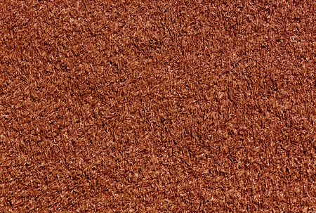 Decorative red grass loan texture. Sport and leisure. Abstract background and texture for designの写真素材
