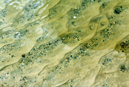 Transparent river water and sandy shore. Natural background.の写真素材