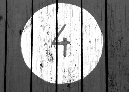 Number four on black and white wooden wall. Nimbers and figures.の写真素材