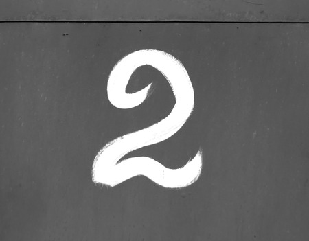 Number two on metal wall in black and white. Numbers and figures.の写真素材