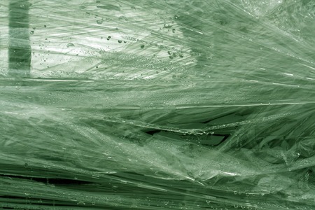 Green color plastic wrap surface. Abstract background and texture for designの写真素材
