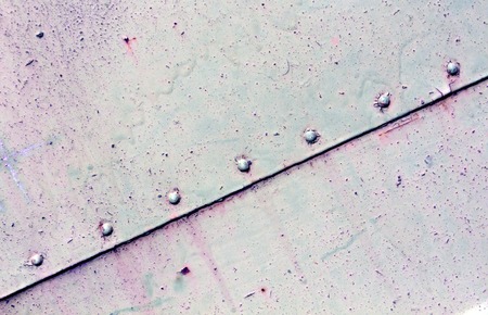 Rusty blue metal plate surface with rivets. Abstract backgrond and texture for design.の写真素材