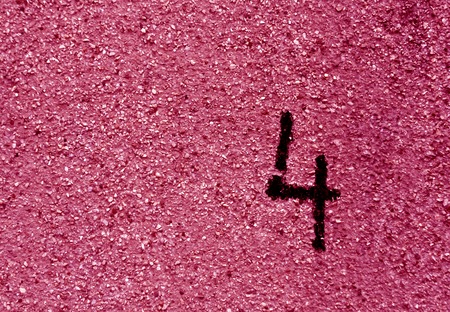 Number four on grungy pink cement wall. Abstract background and texture.の写真素材