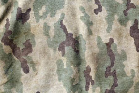 Weathered camouflage uniform pattern. Abstract background and texture for design.の写真素材
