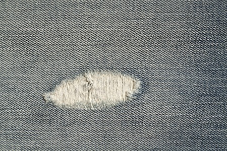 Blue jeans with hole surface. Abstract background and texture.の写真素材