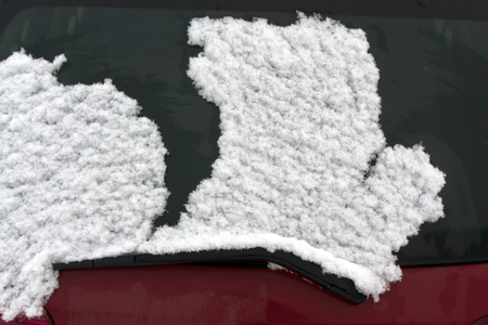 Snow on car glass. Seasonal background.の写真素材