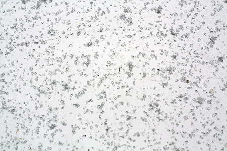Window covered with small snowflackes. Seasonal view and background.