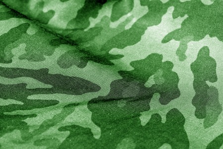 Military uniform pattern with blur effect in green tone. Abstract background and texture.の写真素材