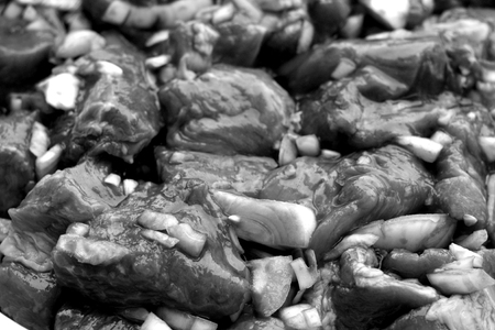 Pork meat with onions ready for bbq in black and white. Food and ingredientes.の写真素材