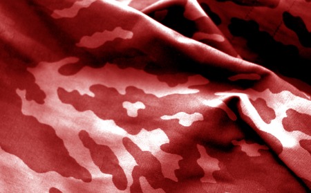 Military uniform pattern with blur effect in red tone. Abstract background and texture.