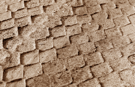 Tyre tracks on sand in brown tone. Abstract background and pattern.の写真素材