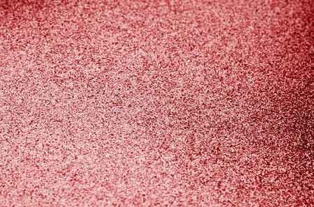 Glittering background in red color with blur effect. Abstract background and texture for design.の写真素材