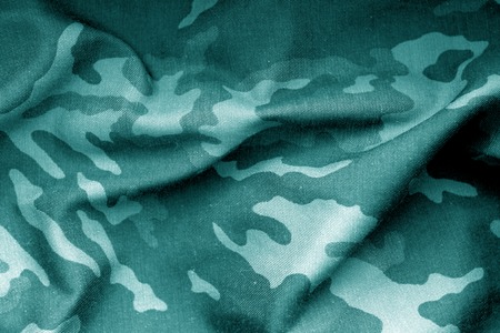 Military uniform pattern with blur effect in cyan tone. Abstract background and texture.の写真素材