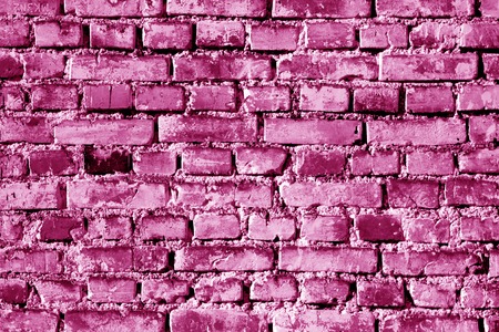 Grungy weahered brick wall in pink tone. Abstract background and texture for design.の写真素材