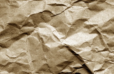 Old crumpled paper with wrinckles in brown color. Abstract background and texture for design.の写真素材