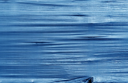 Crumpled transparent plastic surface in navy blue color. Abstract background and texture for design.の写真素材