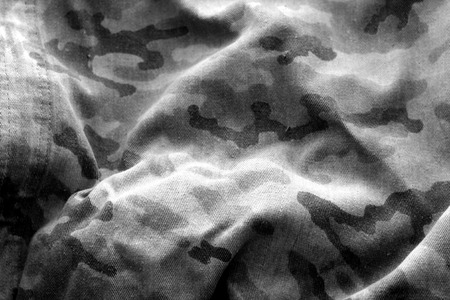 Old camouflage cloth with blur effect in black and white. Abstract background and texture for design abd ideas.の写真素材
