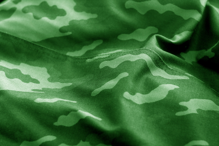 Old camouflage cloth with blur effect in green tone. Abstract background and texture for design abd ideas.の写真素材