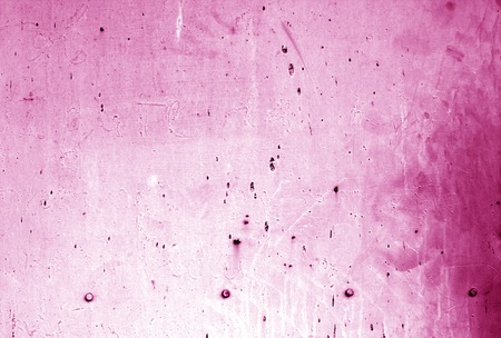 Part grungy metal door with rust in pink color. Abstract architectural background and texture for design.の写真素材