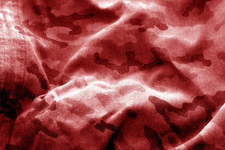 Old camouflage cloth with blur effect in red tone. Abstract background and texture for design abd ideas.の写真素材