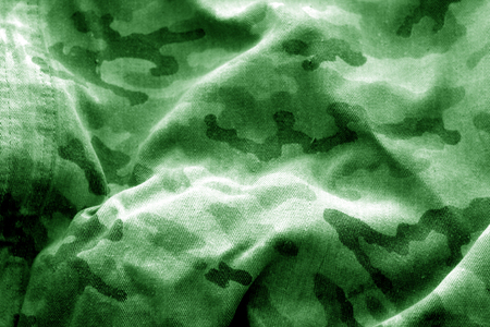 Old camouflage cloth with blur effect in green tone. Abstract background and texture for design abd ideas.の写真素材