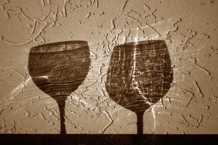 Two wine glasses shadow in brown tone. Abstract backround and view.の写真素材