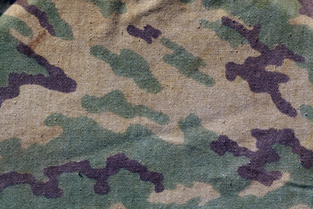 Dirty camouflage cloth with blur effect. Abstract background and texture for design abd ideas.の写真素材
