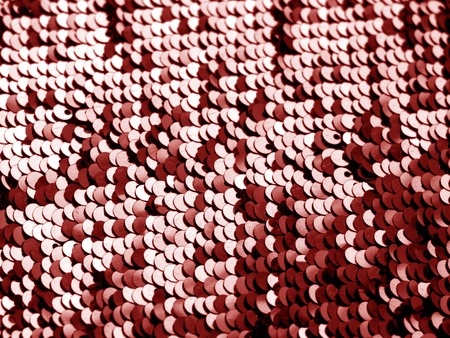 Glittering sequin texture in red color. Abstract background and texture for design.の写真素材
