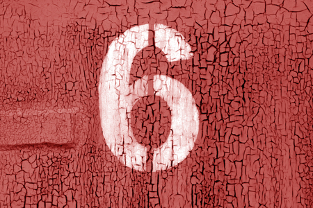 Number 6 in stencil on grungy metal wall in red tone. Abstract background and texture for design.の写真素材