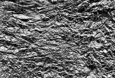 Metal foil texture in black and white. Abstract background and texture for design.