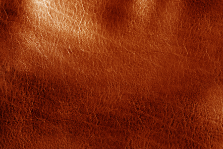 Orange toned leathered leather texture. Abstract background and texture for design and ideas.の写真素材