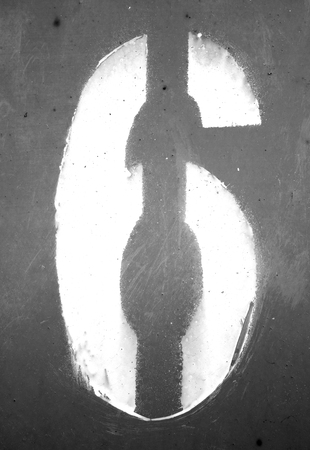 Number 6 in stencil on grungy metal wall in black and white. Abstract background and texture for design.の写真素材
