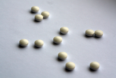 White pills on white with blur. Background and texture for design.の写真素材