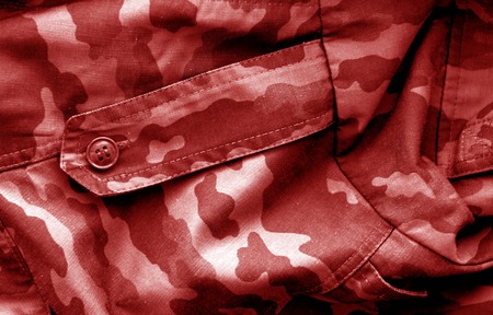 Military uniform pattern with blur effect in red tone. Abstract background and texture.の写真素材