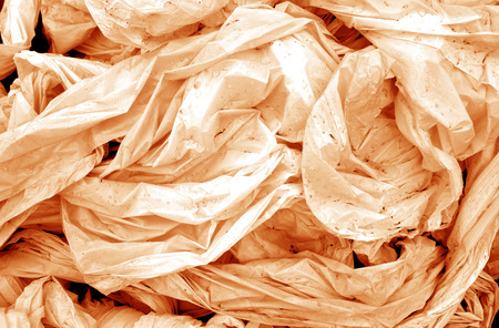 Dirty crumpled pvc in orange tone. Abstract background and texture for design.の写真素材