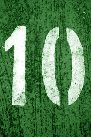 Number 10 in stencil on metal wall in green tone.  Abstract background and texture for design.の写真素材