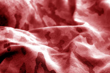 Old camouflage cloth with blur effect in red tone. Abstract background and texture for design abd ideas.の写真素材